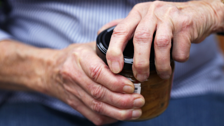 Man trying to open jar