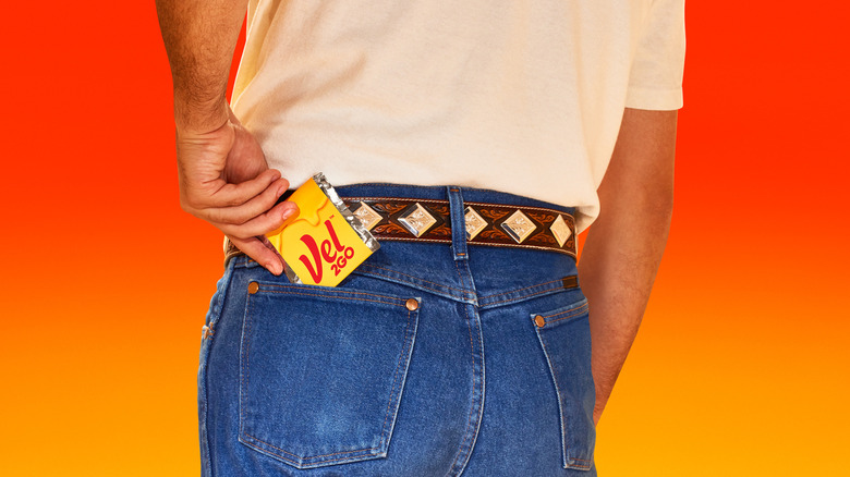 Packet of Vel2Go peeking out of the back pocket of a person's jeans