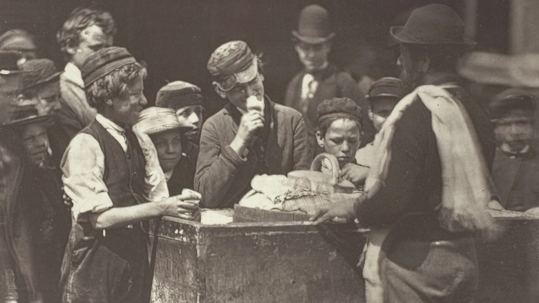 people buy ice cream from old-time vendor