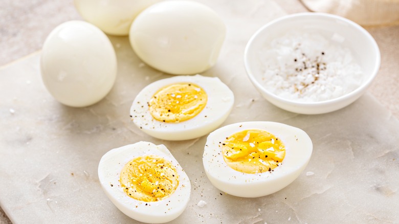 Hard boiled eggs sliced with salt and pepper