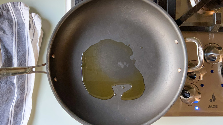 Oil heating in skillet on stove