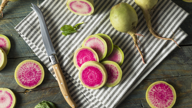 Watermelon radishes with striped towel and knife