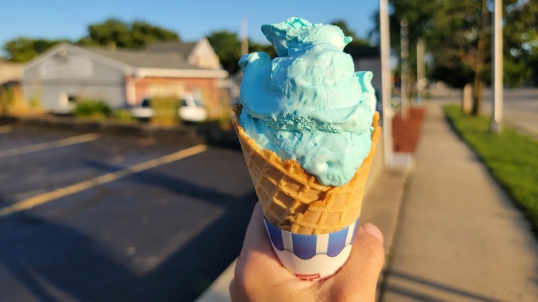Hand holding Blue Moon ice cream cone