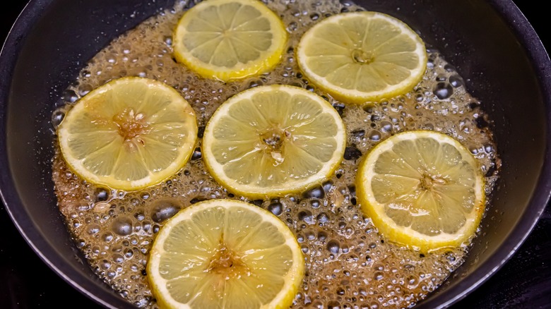 lemon slices caramelizing in frying pan