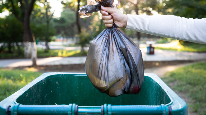 Throwing garbage into trash can