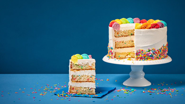 A confetti cake with a slice removed