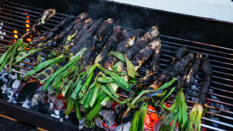 charred calçot onions on a grill