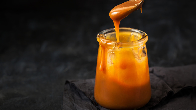 jar of caramel sauce with spoon