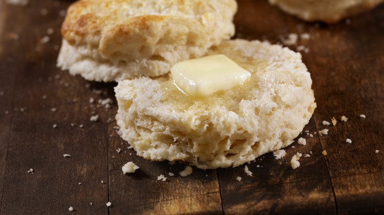 Butter spread between a halved biscuit