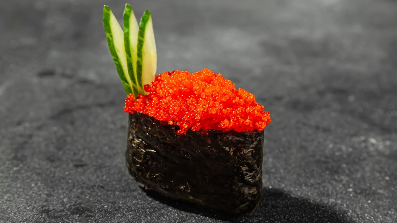 sushi with tobiko on top and cucumber