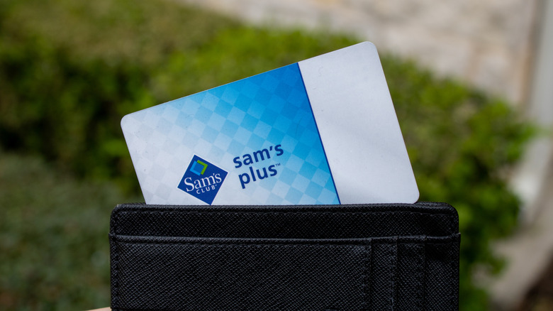 A Sam's Club Plus membership card pokes out of a black leather wallet