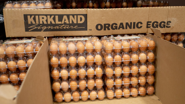 Stacks of Kirkland Signature organic eggs are stored in cardboard boxes