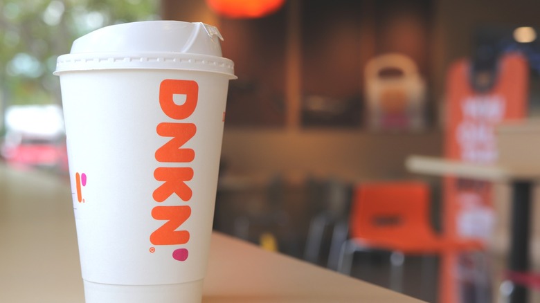 Dunkin Donuts takeout coffee cup on table