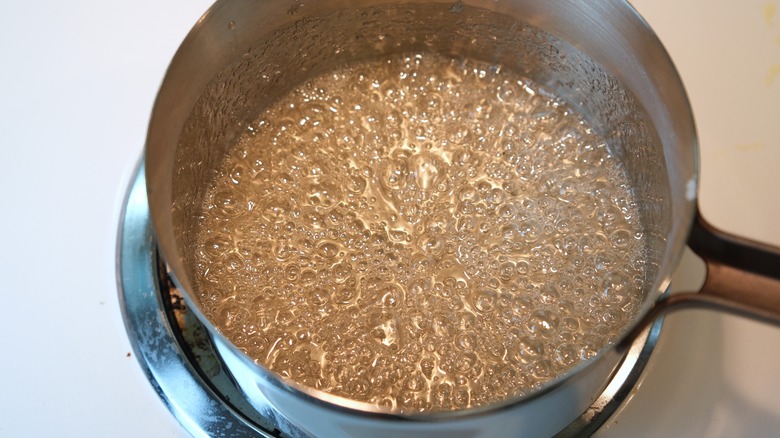 Boiling sugar in a pan on stovetop