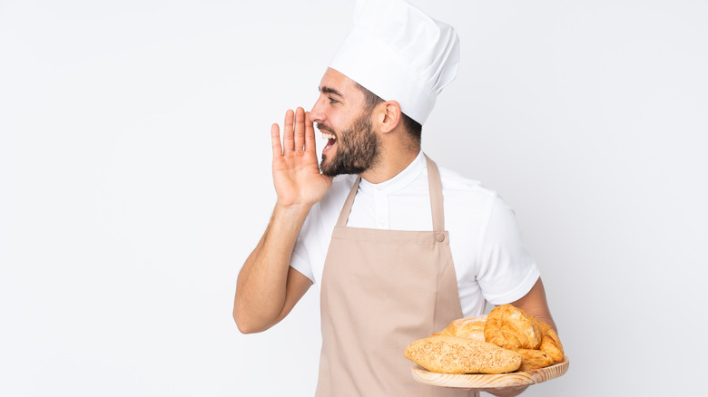 Chef with bread calling to someone
