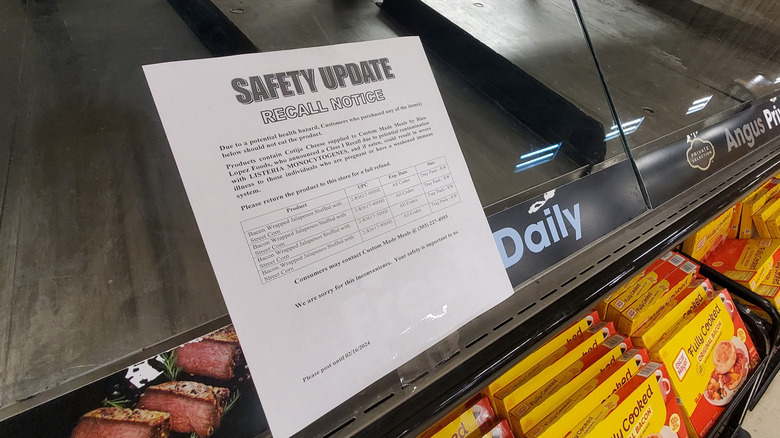 A recall notice sits in a grocery store's display window