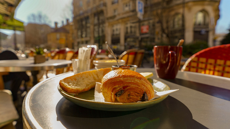 French breakfast of tartine, jam, and pain au chocolat, at an outdoor cafe