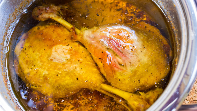 Duck legs in duck fat in pot