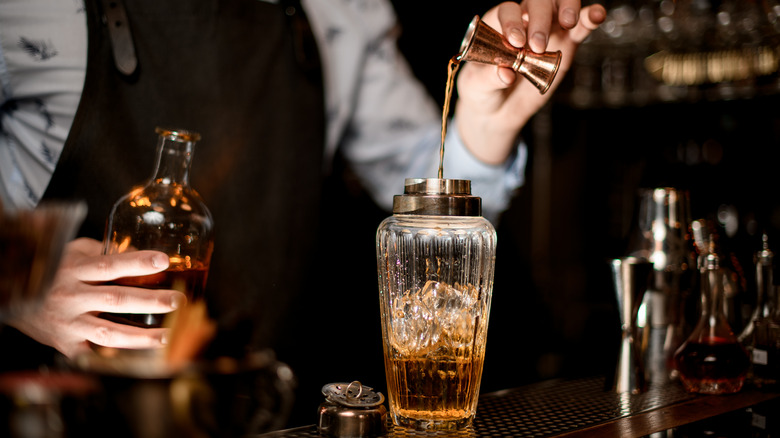 Bartender pouring liquor into shaker