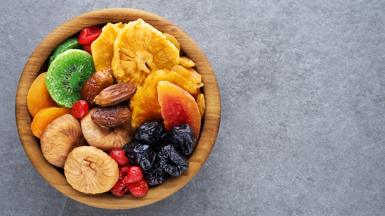 wooden bowl full of dried fruits