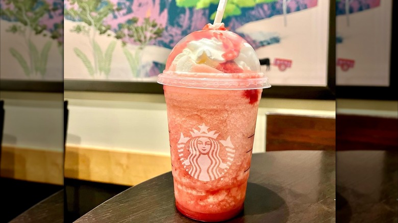 Pink Starbucks Starburst Frappuccino on table.