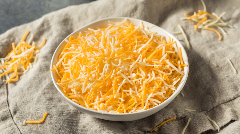 Bowl of grated cheddar cheese