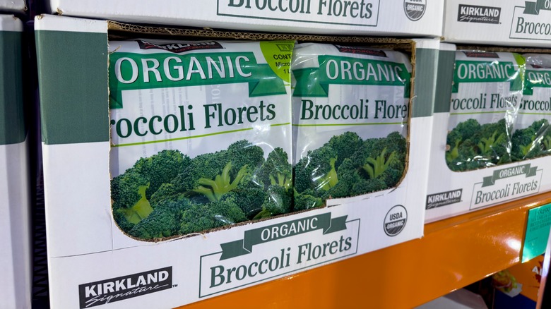 Bags of Kirkland Signature brand frozen broccoli florets on Costco shelf