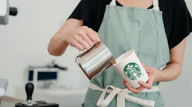 Barista making a Starbucks coffee
