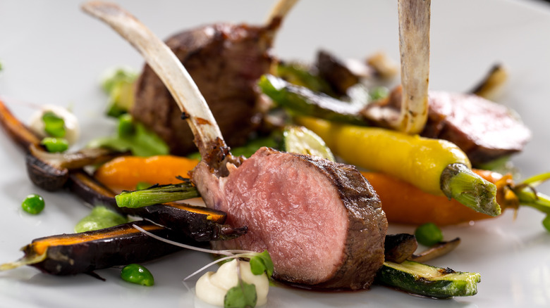 Plate of frenched lamb chops with vegetables