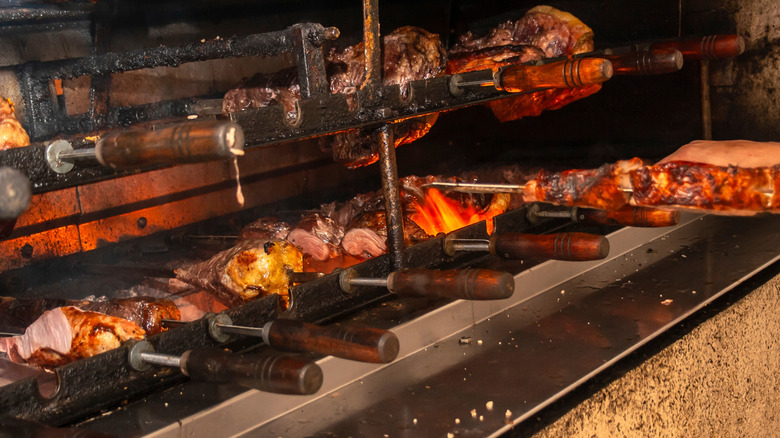 Skewers of meat being cooked on a churrascaria