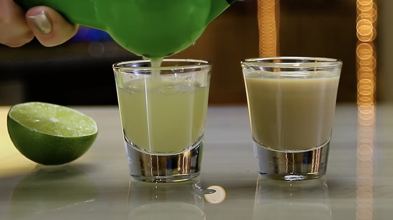 Shot glass of Irish cream and lime juice