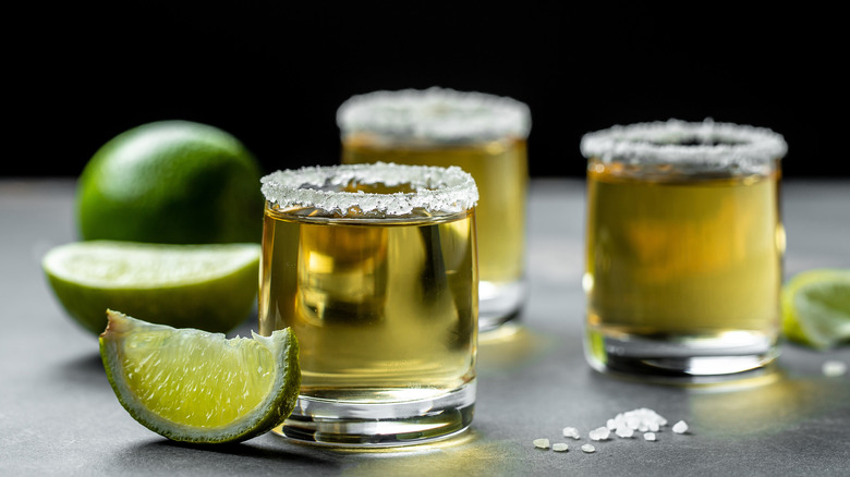 Shots of alcohol with lime garnish