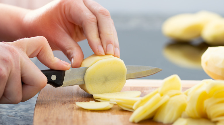 cutting potatoes with knife