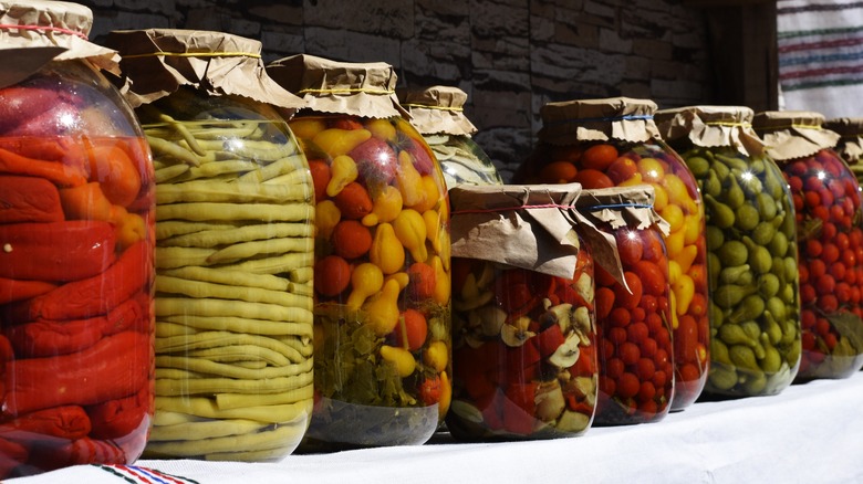 home jars of pickled peppers, green beans, and veggies