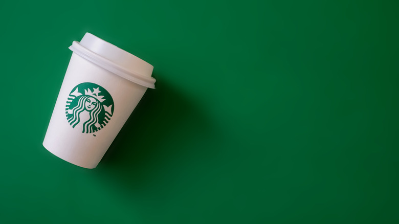 Starbucks cup on green background