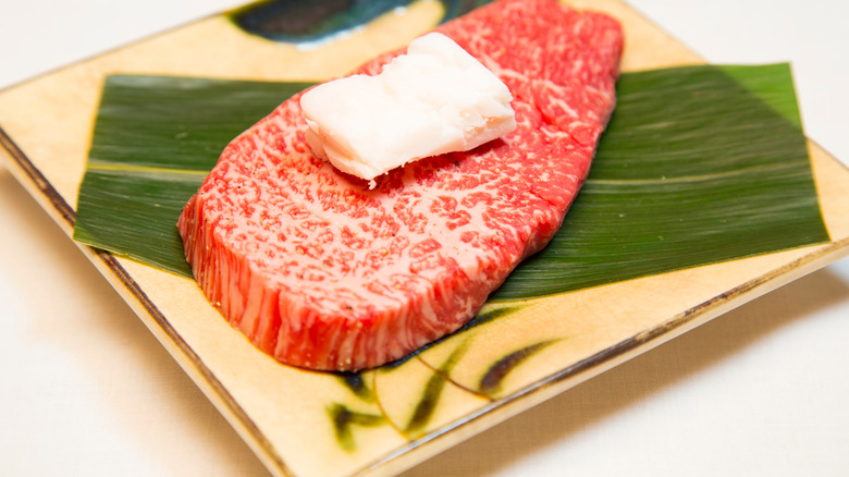 raw Kobe beef topped with tallow piece