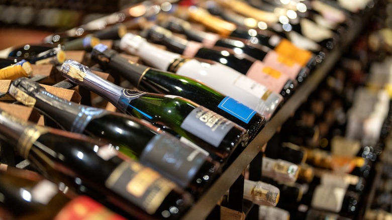 A rack of various sparkling wines in a store