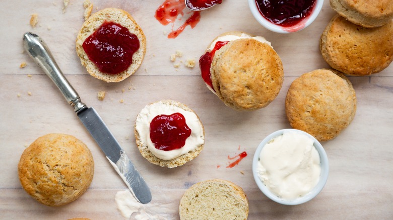 scones with red jams and clotted cream