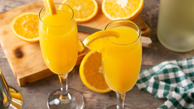 mimosas with an orange garnish