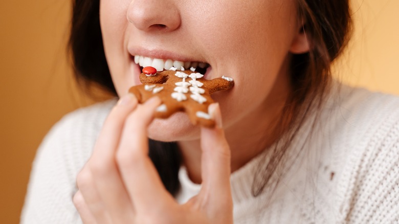 woman eating gingerbread cookie