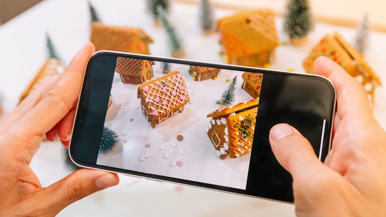 taking a photo of gingerbread houses