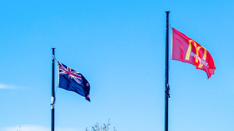 New Zealand flag flying next to a McDonald's flag