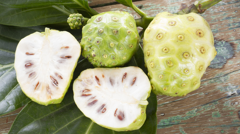 Whole and sliced noni fruits