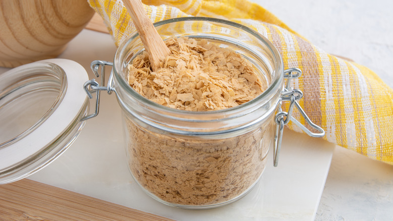 Nutritional yeast flakes in clear mason jar with lid