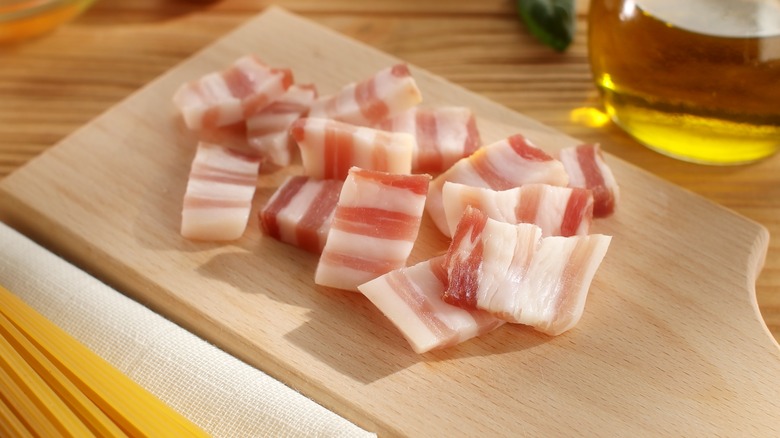 cubed raw pancetta in pan