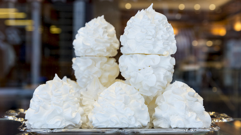 Meringues piled atop a silver tray