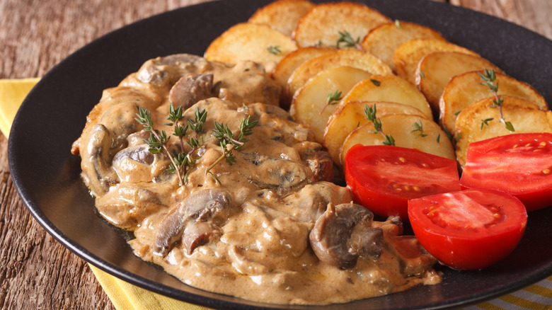 Steak diane with potatoes and tomatoes