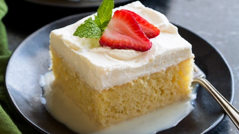 Tres leches cake with strawberry garnish