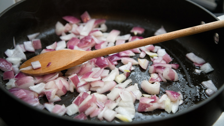 Red onions cooking in pan