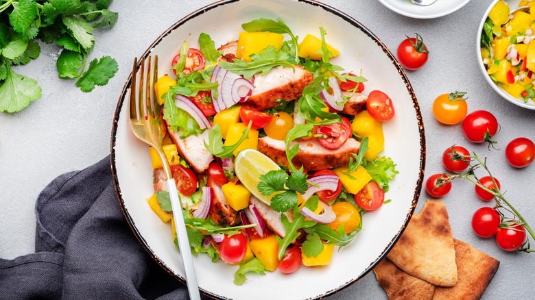 Chicken salad with tomato, onion, herbs, and citrus